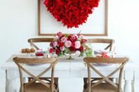 a red heart made of paper on mesh is a cool decor idea for a wedding, it can be easily DIYed