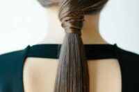 a sleek twisted low ponytail is a stylish idea for a modern or minimalist bride