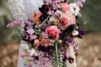 a stunning dimensional purple, lilac, coral and white wedding bouquet is amazing to add some color