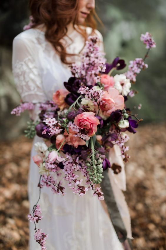 a stunning dimensional purple, lilac, coral and white wedding bouquet is amazing to add some color