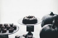 a super refined dessert table done in all-black with black pumpkins and silver calligraphy is perfect for your Halloween bridal shower