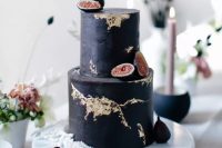 a textural black wedding cake with gold leaf and fresh figs is a beautiful and cool idea for a modern fall wedding done with black