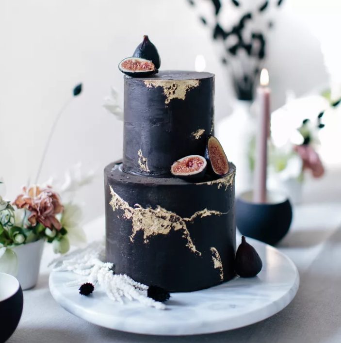 a textural black wedding cake with gold leaf and fresh figs is a beautiful and cool idea for a modern fall wedding done with black