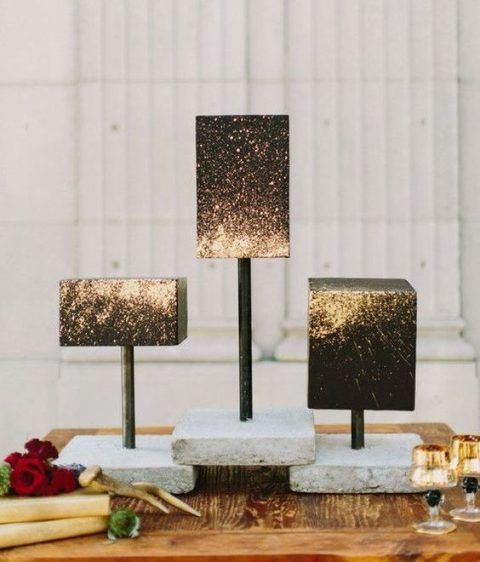 black square wedding cakes decorated with gold glitter that creates an ombre effect is a gorgeous arrangement for a modern wedding