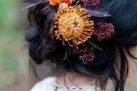 bold floral hair detailing with yellow pincushion proteas and dark foliage is idea for a fall woodland bride