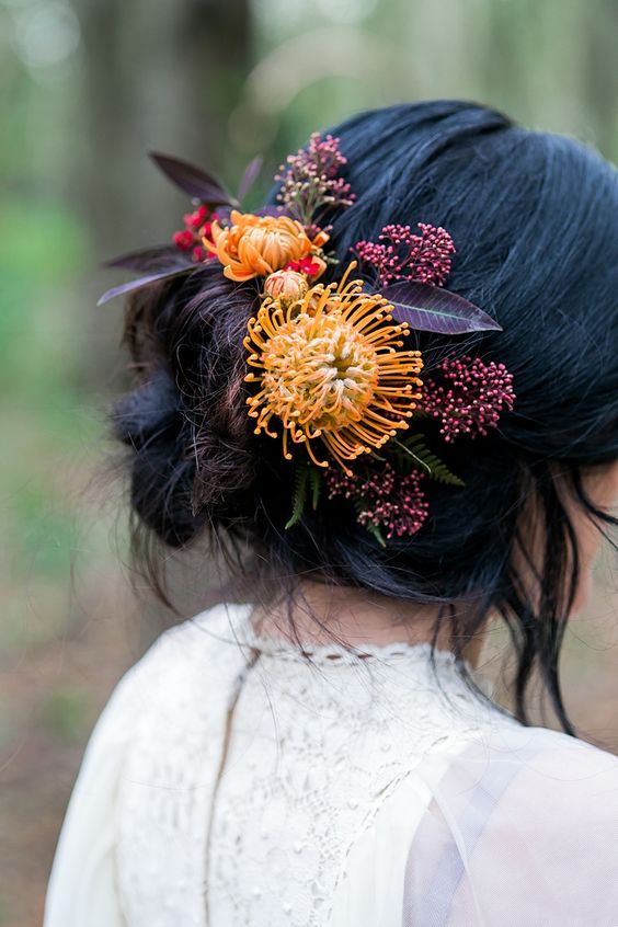 bold floral hair detailing with yellow pincushion proteas and dark foliage is idea for a fall woodland bride