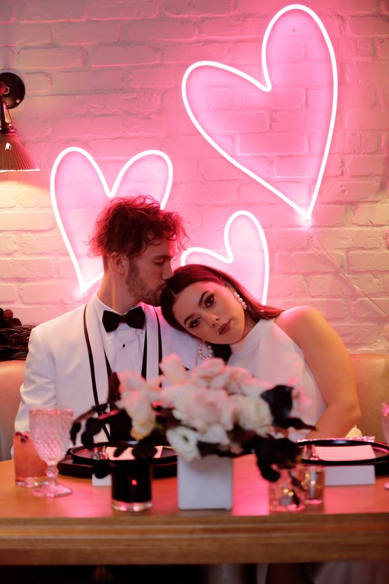 bright pink neon hearts can be used as your wedding sweetheart table backdrop or for decorating any other zone