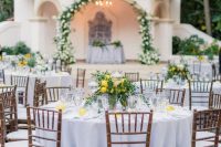 chic and elegant wedding tablescapes done with lemons and greenery and lemon centerpieces are adorable
