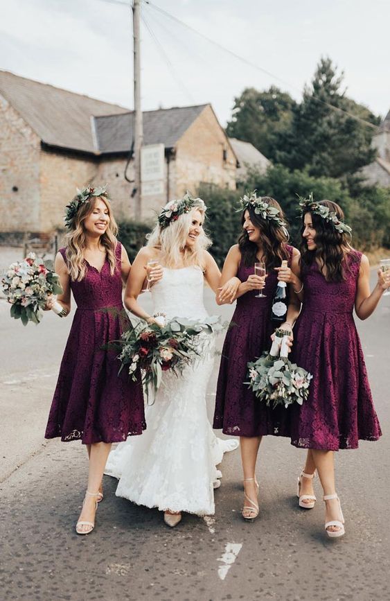 Cool plum colored midi bridesmaid dresses with V necklines and no sleeves are cool for a fall wedding
