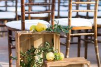 highlight your wedding ceremony space with crates with greenery and lemons to remind where you are tying the knot