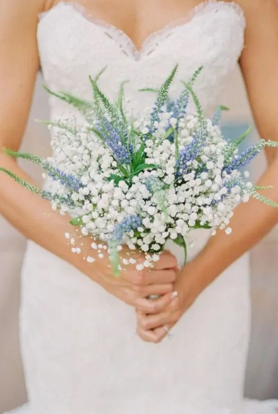 a beautiful bouquet of blue delphinium and baby's breath looks very refreshing and cute