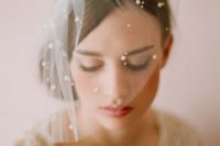 a birdcage veil with pearls looks very chic and ethereal and will accent your bridal look in a refined way