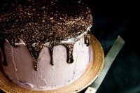 a blush textural wedding cake with black and gold glitter with drip is veyr glam, chic and yummy