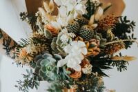 a boho wedding bouquet of succulents, cacti, white and rust blooms, greenery for a summer or tropical boho wedding