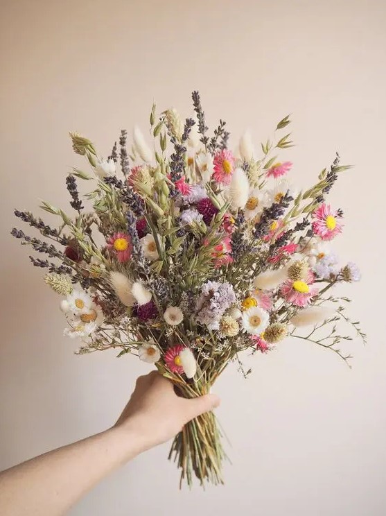 a bright dried and natural flower wedding bouquet with daisies, astilbe, lavender, grass, twigs is a fun idea for a summer boho bride