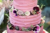 a bright pink textural wedding cake with greenery, blooms, fresh berries and mini meringues is a fantastic and chic idea