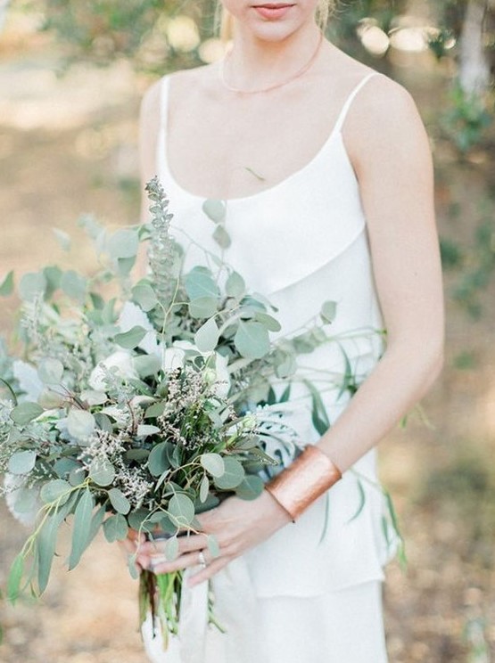 a casual greenery wedding bouquet of eucalyptus and some blooming branches looks very chic