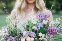 a chic and lush lilac wedding bouquet with neutral and blush blooms, blooming branches and greenery is a lovely idea for spring