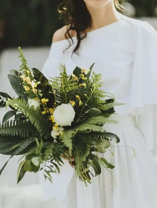 a chic wedding bouquet with ferns, leaves and white and yellow blooms is a unique idea