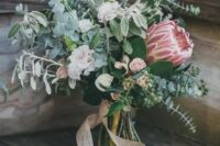 a cute wedding bouquet with eucalyptus, blush garden roses and thistles plus blush ribbons