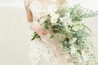 a delicate cascading wedding bouquet with light-colored greenery, neutral blooms and herbs is a lovely idea to rock