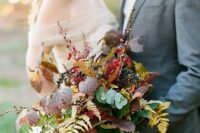 a fall boho romantic wedding bouquet with no blooms, berries and foliage of all colors possible