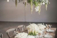 a geometric overhead wedding decoration of white blooms and much greenery