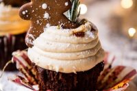 a gingerbread cupcake with frosting, caramel drip, greenery and a gingerbread cookie is a lovely idea for a NYE wedding