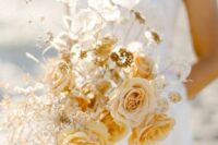 a golden wedding bouquet with marigold and blush blooms, lunaria and some dried herbs for a fall bride