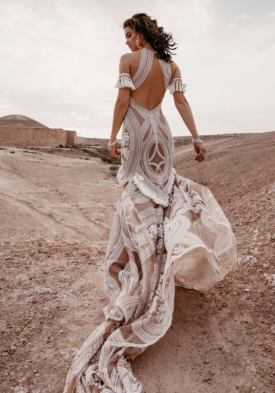 a gorgeous East wedding gown by Rue de Seine, sheer nude with white lace, a cutout back, a halter neckline and tassels