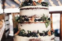 a gorgeous fall naked wedidng cake decorated with blackberries, blueberries, figs and greenery looks very yummy