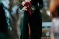 a green velvet A-line wedding dress with a deep neckline, long sleeves, a front slit is a gorgeous solution for a modern fall bride