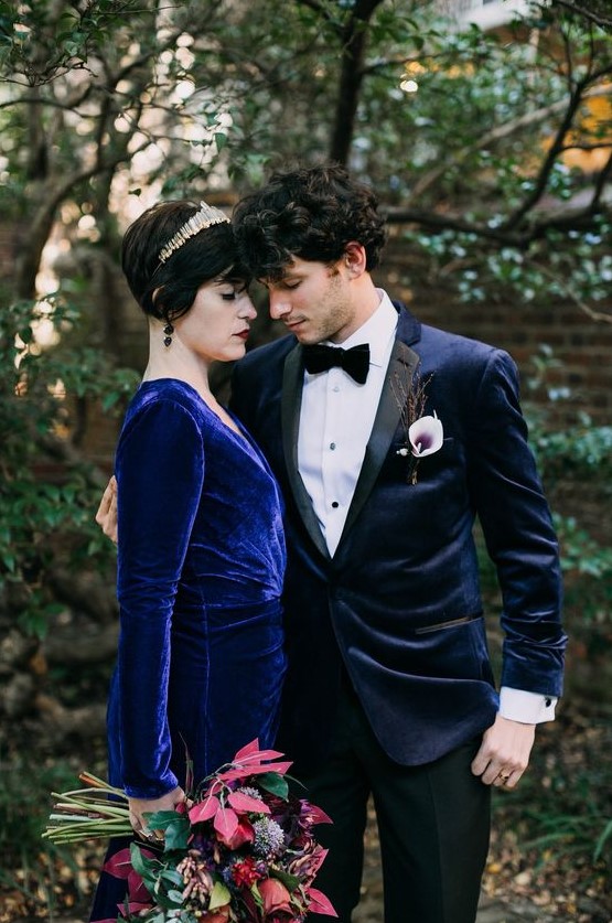 a groom's look with a midnight blue velvet tux with black lapels, a bride wearing an electric blue velvet wedding dress