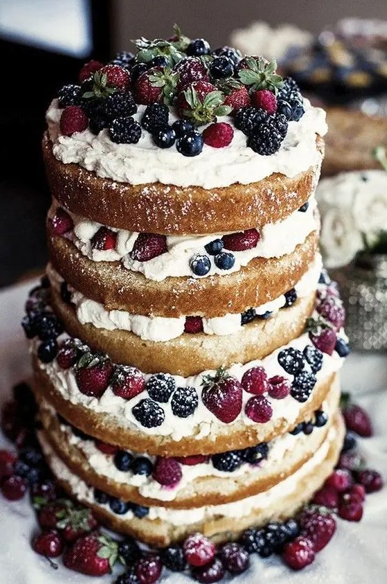 a jaw-dropping naked wedding cake with frosting and fresh berries is a fantastic idea for a summer wedding