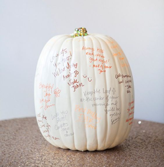 a large pumpkin painted white with gold glitter is a fun and easy DIY idea for a fall wedding guest book