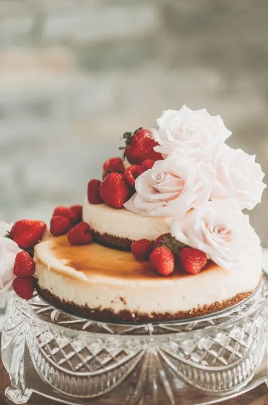 a lovely two tier wedding cheesecake with fresh strawberries and blush roses is a very beautiful idea to try