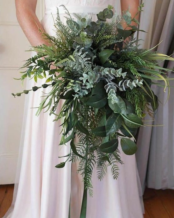 a lush textural and cascading wedding bouquet with pale greenery, ferns, foliage and other stuff