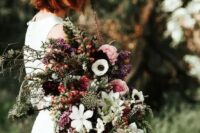a moody textural fall wedding bouquet with touches of pink, plum and textural greenery