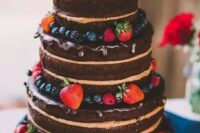 a naked chocolate wedding cake with chocolate drip and fresh berries is a yummy and cool idea for a rustic or relaxed wedding