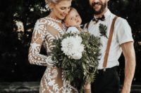a nude lace A-line boho wedding dress with a high neckline and long sleeves and a train