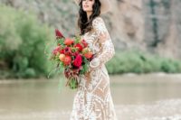 a nude lace boho A-line wedding gown with long sleeves, a high neckline and a train