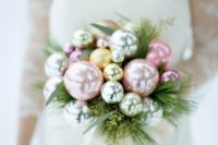 a pastel Christmas wedding bouquet with evergreens, foliage is a very tender idea for a winter wedding