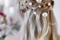 a romantic half updo with a braid halo accented with pearl pins of various sizes looks really chic and cool
