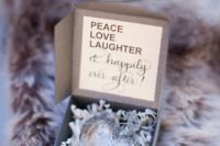 a silver heart ornament in a box is a cute and chic winter or holiday wedding favor