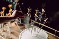 a simple white plain wedding cake with star toppers is a cool glam NYE idea that can be even DIYed