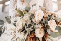 a sophisticated blush wedding bouquet with white touches, pale greenery and air plants for a beach bride