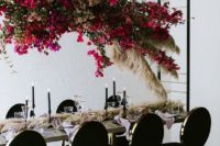 a suspended bougainvillea floral and pampas grass overhead centerpiece for a modern chic wedding reception