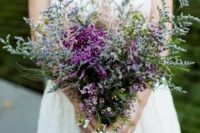 a textural and bold wedding bouquet of purple dahlias, waxflower and lots of simple grasses and wildflowers is amazing for a summer wedding
