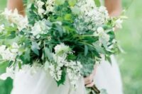 a very lush and textural greenery wedding bouquet with lots of greenery, succulents and white flowers is a cool and fresh idea