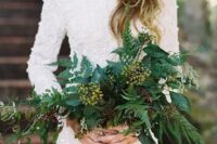 a very textural and a bit cascading wedding bouquet of greenery and some berries for a tropical bride